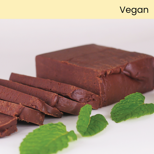 Slice of Color Me Flavors vegan chocolate mint fudge with whole mint leaves